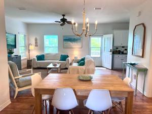 a living room with a table and chairs at 4014 Rookery 3 Cottage with two Pools and Beach Amenities in Gulf Highlands