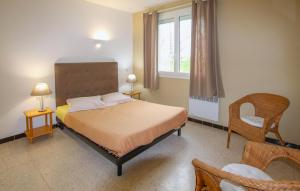 a bedroom with a bed and a window and a chair at Nice Home In Bourdeaux With Kitchen in Bourdeaux