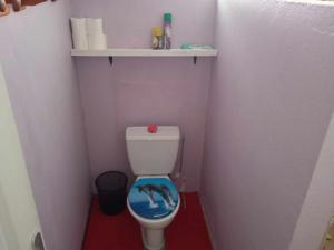 a small bathroom with a toilet with a dolphin on the seat at Chez Angele in Faie