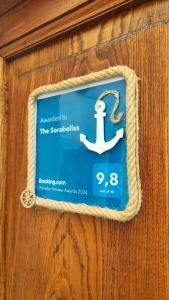 a sign with an anchor on a wooden wall at The Sorabellas in Gaeta