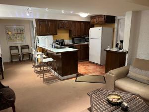 a kitchen and living room with a couch and a refrigerator at fabulous beach side apartment in Vancouver