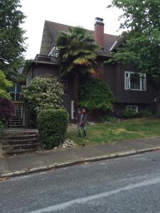 a person standing in front of a house at fabulous beach side apartment in Vancouver