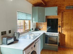 a kitchen with a sink and a counter top at Crown Hill Lodge in Cononley