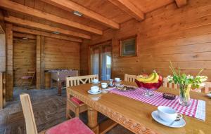 a wooden dining room with a wooden table and chairs at Beautiful Home In Vinogradi Ludbreski With Heated Swimming Pool in Ludbreg