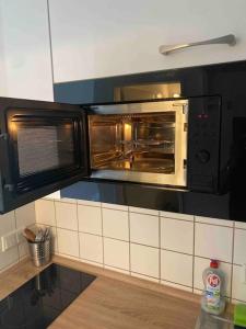 a kitchen with two microwaves on the wall at Schöne, kleine, gemütliche Wohnung - Stadtmitte in Mainz +2 photos