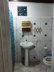 a bathroom with a sink and a toilet at Albergue Flor do Caribe in Parintins +40 photos
