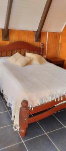 a large wooden bed in a room with at Cabañas Refugio verde in El Soberbio
