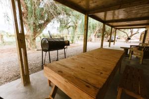 a room with a wooden table and a large window at Viñedos de la Luna in Fiambala