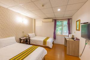 Voodi või voodid majutusasutuse Yishin Garden B&B toas