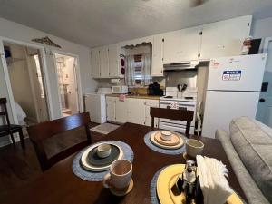 a kitchen and living room with a table and a couch at Bayou Serenity Hideawayfast Wificomfy Bed in Lake Charles