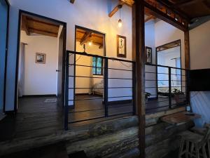 a room with a wooden floor and a balcony at CABAÑA GLAMPING HOUSE in Calarcá