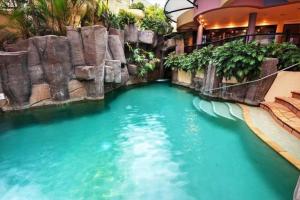 a pool in the middle of a water slide at Nautilus Resort - Private Apartment in Mooloolaba