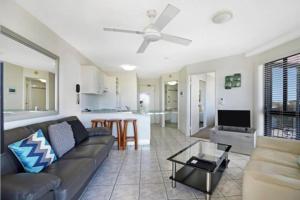 a living room with a couch and a table at Nautilus Resort - Private Apartment in Mooloolaba