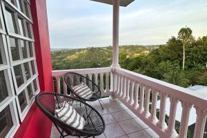 two chairs sitting on a balcony with a view at Casa El Coqui in Luyando