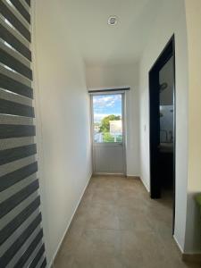 un couloir avec une porte et une fenêtre dans l'établissement Villa Diana-Condominio campestre, à Girardot