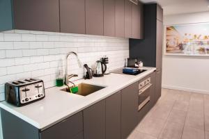 a kitchen with a sink and a stove at Miami High Town View 1610 in Miami