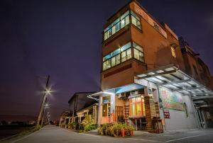 a tall building with a clock on top of it at New Fox Guest House in Zhuangwei