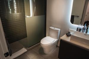 a bathroom with a toilet and a shower and a sink at Miami High Town View 1610 in Miami