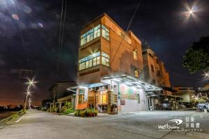 a tall building with lights on it at night at New Fox Guest House in Zhuangwei