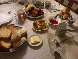 a table topped with plates of bread and other foods at Mi habitación en Salta cerca de todo ! in Salta
