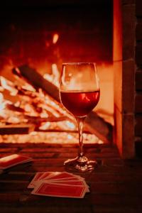 a glass of wine sitting in front of a fireplace at Sereno Vista in Santa Cruz