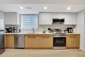 a kitchen with white cabinets and a stove top oven at New Two Bedroom Apartment In Waterloo in Waterloo