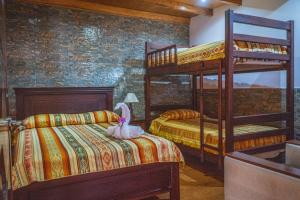 a bedroom with two bunk beds with a bunny on the bed at Hospedaje Cabaña Familiar in Otavalo