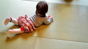 a little girl laying on the floor at Watermark Hotel Kyoto HIS Hotel Group in Kyoto