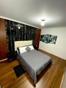 a bedroom with a bed and two pictures on the wall at Hotel Canela 96 in Bogotá