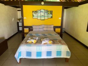 a bedroom with a bed with two stuffed animals on it at Serenity Bungalows in Port-Olry