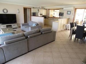 a living room with a couch and a kitchen at Corleighson @ Oyster on Point in Stansbury