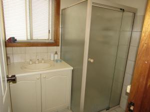 a bathroom with a sink and a glass shower at Corleighson @ Oyster on Point in Stansbury +14 photos