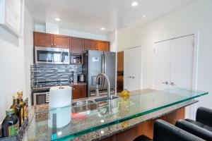 a kitchen with a sink and a counter top at Harbour Front Luxury Condo 2 Bed 2 Bath in Toronto
