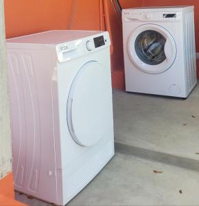 a washing machine sitting next to a washer at ZionGates in Castries
