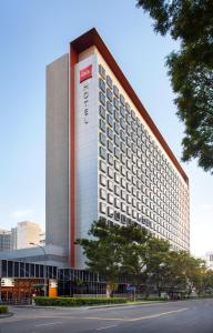 a building with a hotel sign on the side of it at Ibis Singapore on Bencoolen in Singapore