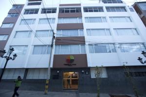 a man walks in front of a building at Tierra Viva Puno Plaza in Puno