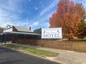 a sign for a motel in front of a fence at Corryong County Inn in Corryong