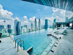 a swimming pool on top of a building with a city skyline at Imperial lexis KLCC By AR Hospitality in Kuala Lumpur
