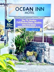 a sign for an ocean inn motel on a street at Ocean Inn Motel in Auckland