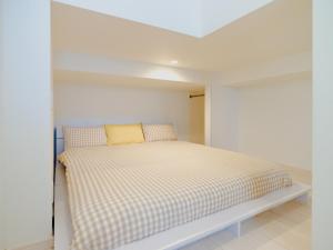 a bedroom with a bed in a white room at YOUR ROOM Kumamoto Sta little 101 Vacation STAY 73968v in Kumamoto