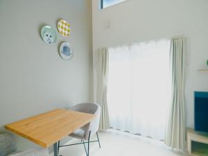 a dining room with a table and a window at YOUR ROOM Kumamoto Sta little 102 Vacation STAY 75686 in Kumamoto