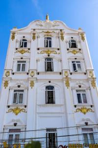 a tall white building with windows on top of it at Hotel Trâm Anh 2 in Nhơn Trạch