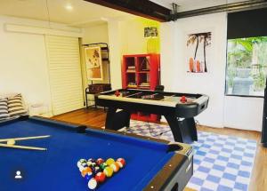 a living room with a pool table in a room at Canto do Sol - 4BR Avoca Getaway in Avoca Beach