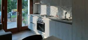 a kitchen with a stove and a sink and a window at Alloggio il Giglio in Schio