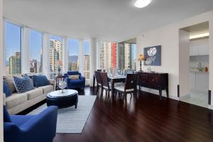 a living room with a couch and a table at Breathtaking Downtown Condo with Stunning Harbor Views! in Vancouver