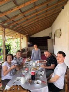 a group of people sitting around a table eating food at Adam-Eva Hotel in Khiva