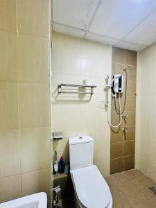 a bathroom with a toilet and a shower at ITCC Manhattan Suites by AURORA in Penampang