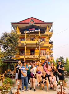 a group of people posing in front of a hotel national park at Hotel National Park- A Peaceful Family Home in Sauraha in Chitwan