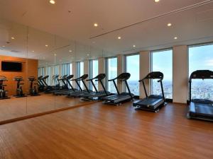a gym with a row of exercise bikes in a room at Nagoya Prince Hotel Sky Tower in Nagoya