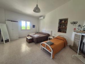 a living room with two beds and a couch at Villa leone 2 in Pisticci